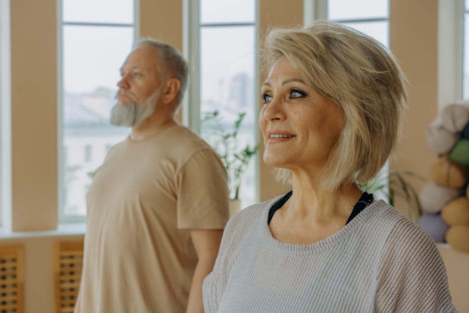 A group of people performing gentle chest stretching exercises in a light, airy room, emphasizing recovery and togetherness.