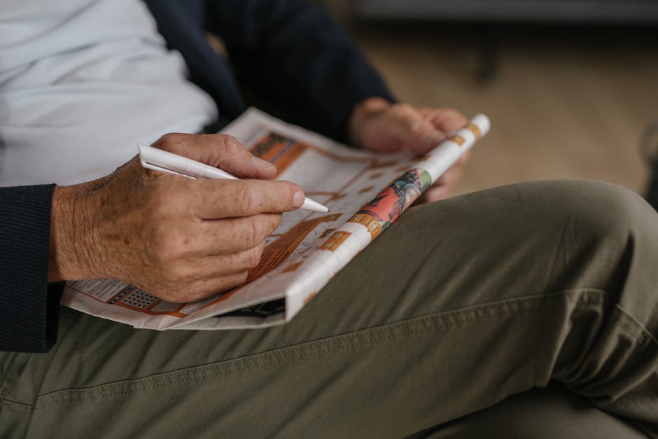 A person solving a crossword puzzle while using a standing desk or treadmill